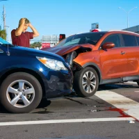 two-cars-collided-at-an-intersection-a-blue-sedan-and-an-orange-suv